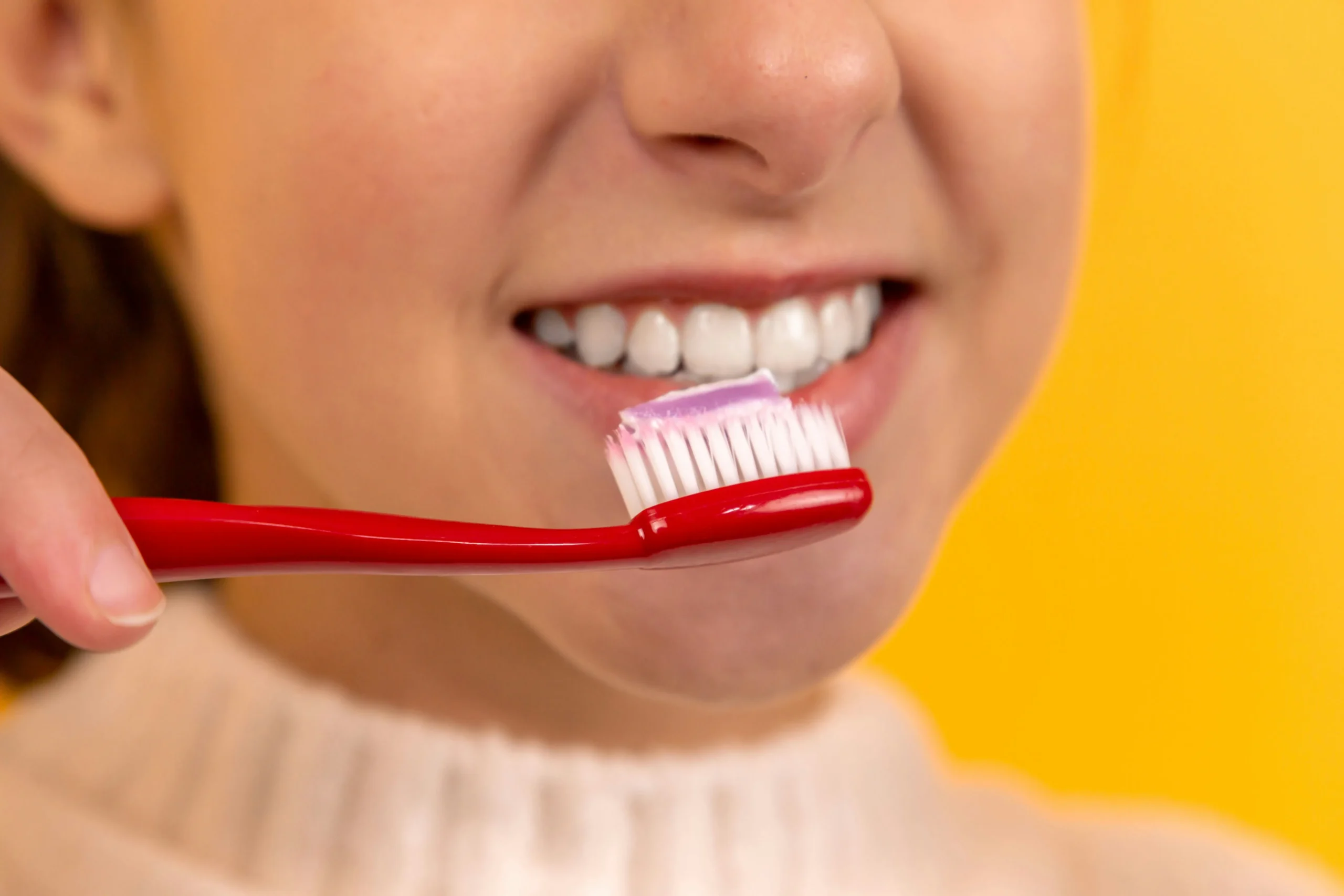 Child brushing teeth with a toothbrush
