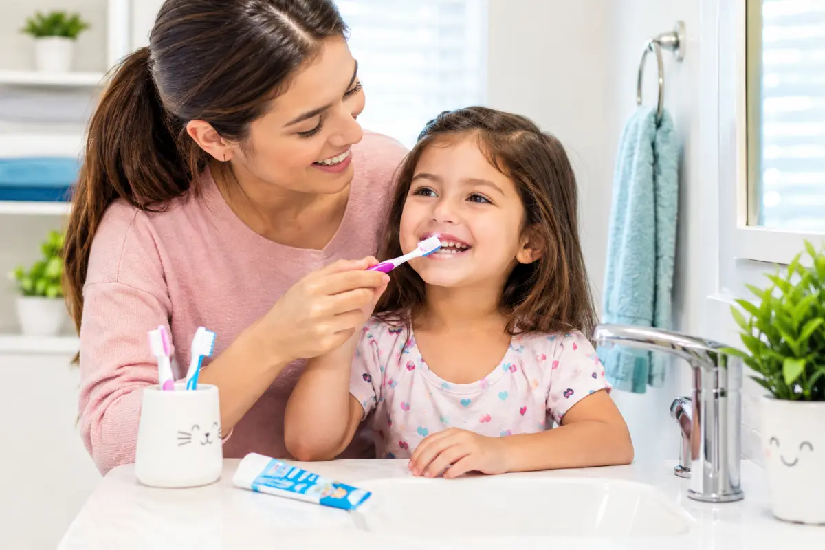 Best Toothpaste for Kids - parent helping child brush teeth